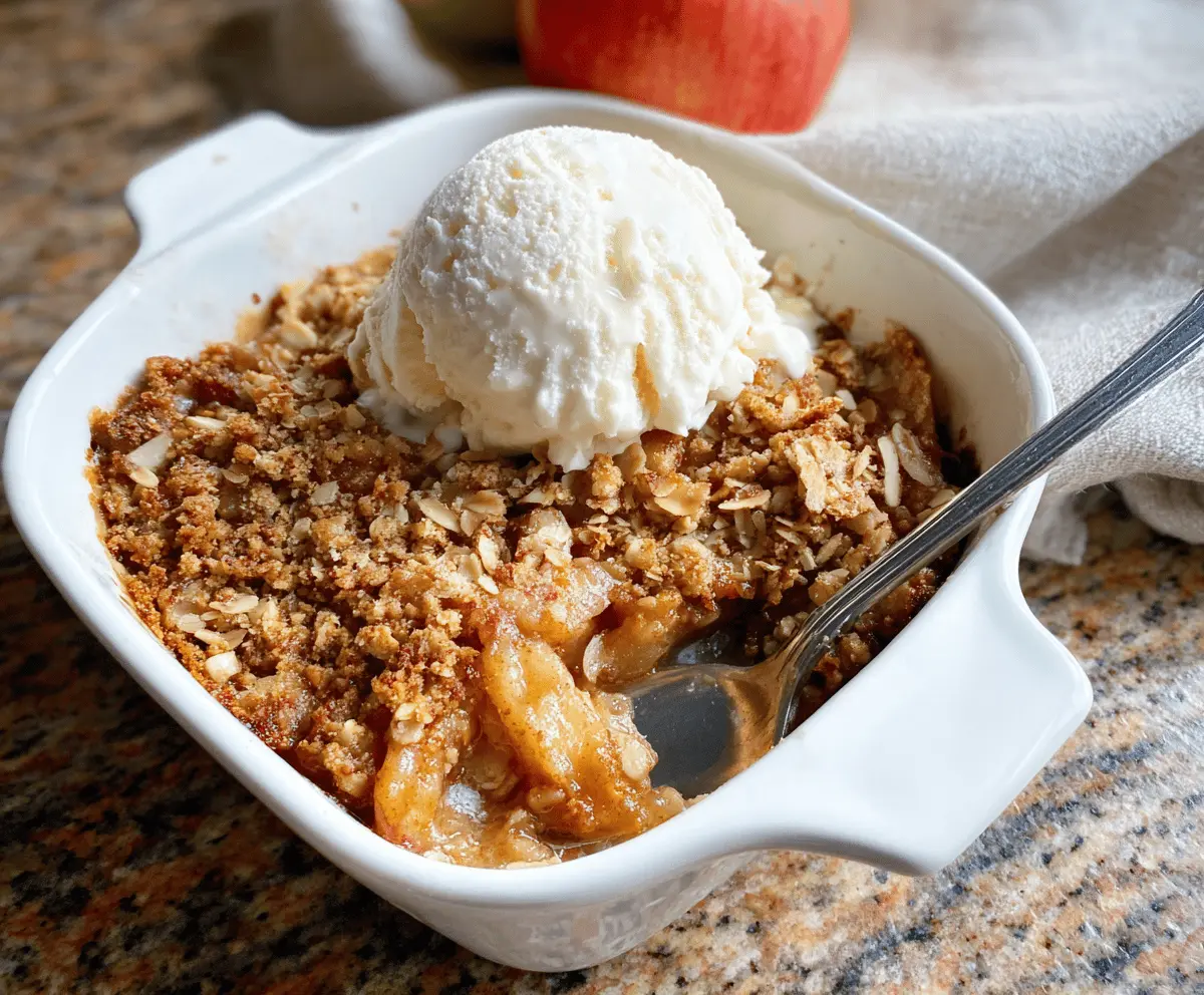 Delicious Paleo Apple Crisp topped with cinnamon and nuts, served in a rustic baking dish