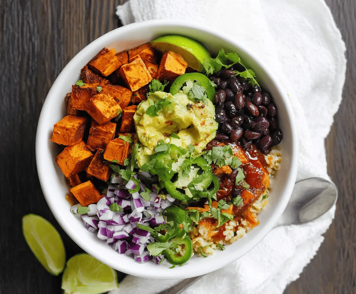 Delicious Chipotle Sweet Potato Burrito Bowl with fresh vegetables and spicy sauce.