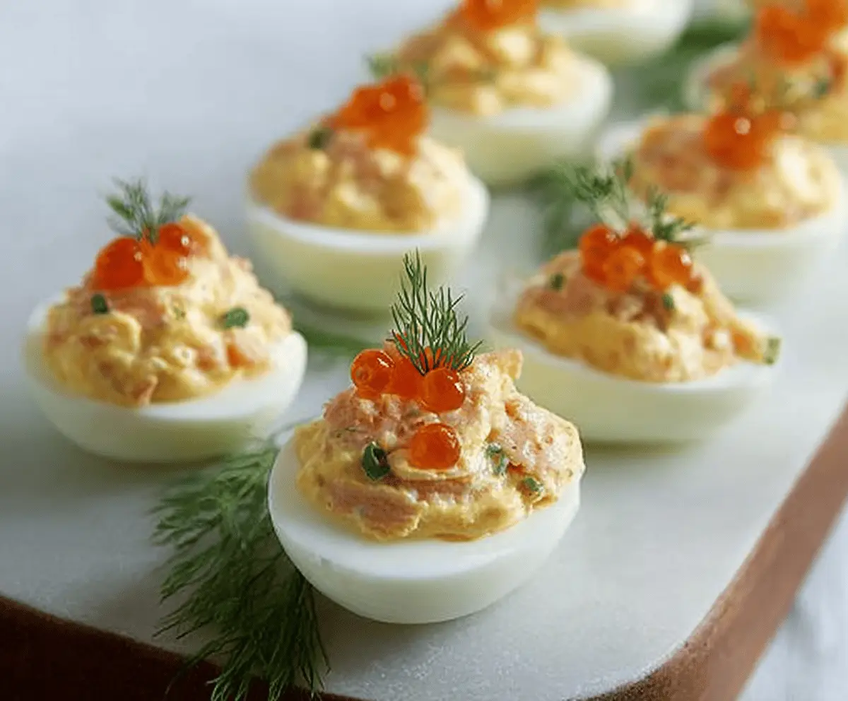 Delicious smoked salmon stuffed eggs garnished with fresh herbs for a savory appetizer.
