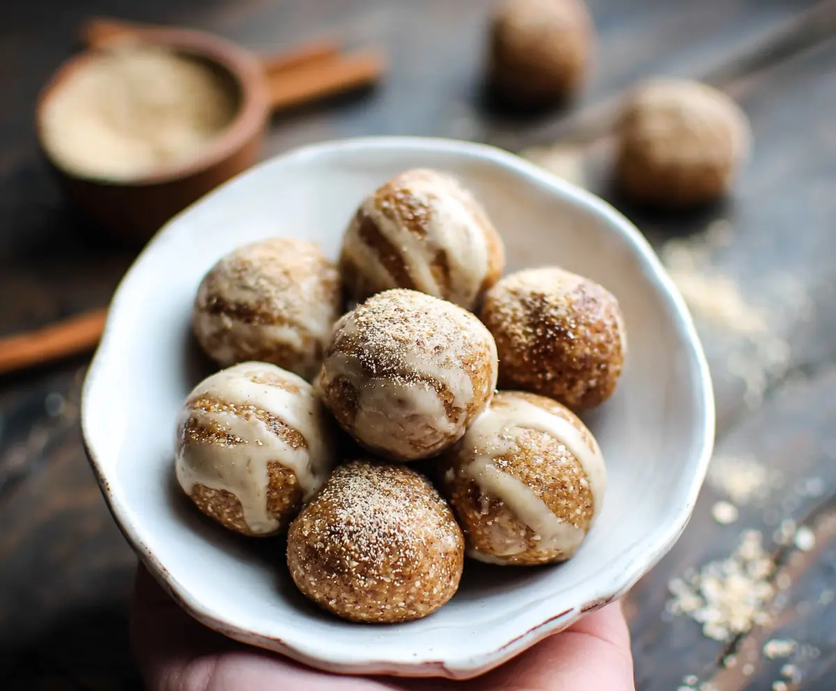 Close-up of cinnamon roll energy bites with a swirl design and a golden-brown appearance.