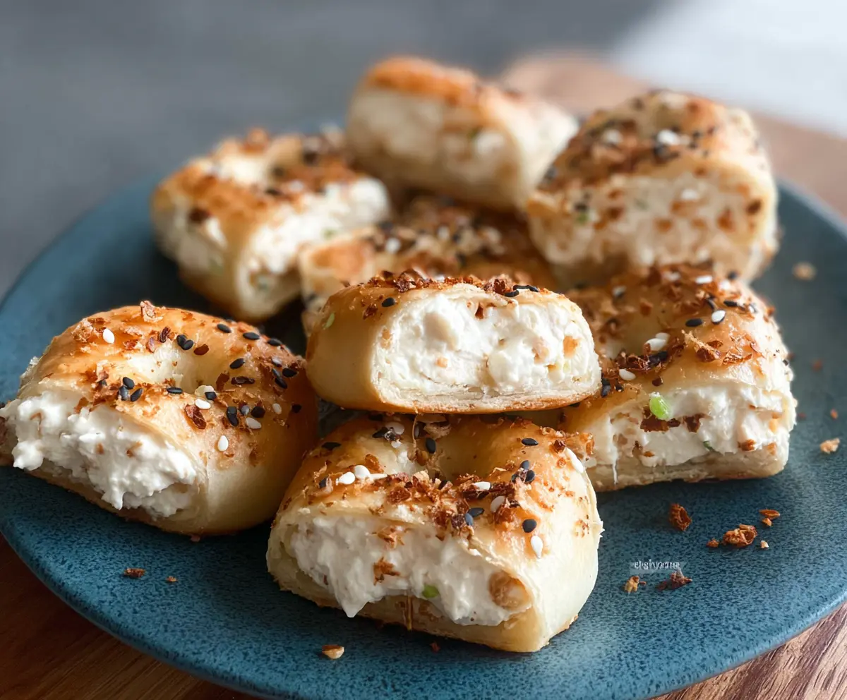 Delicious Tortilla Cream Cheese Bagel Bites topped with fresh herbs and crispy bacon.