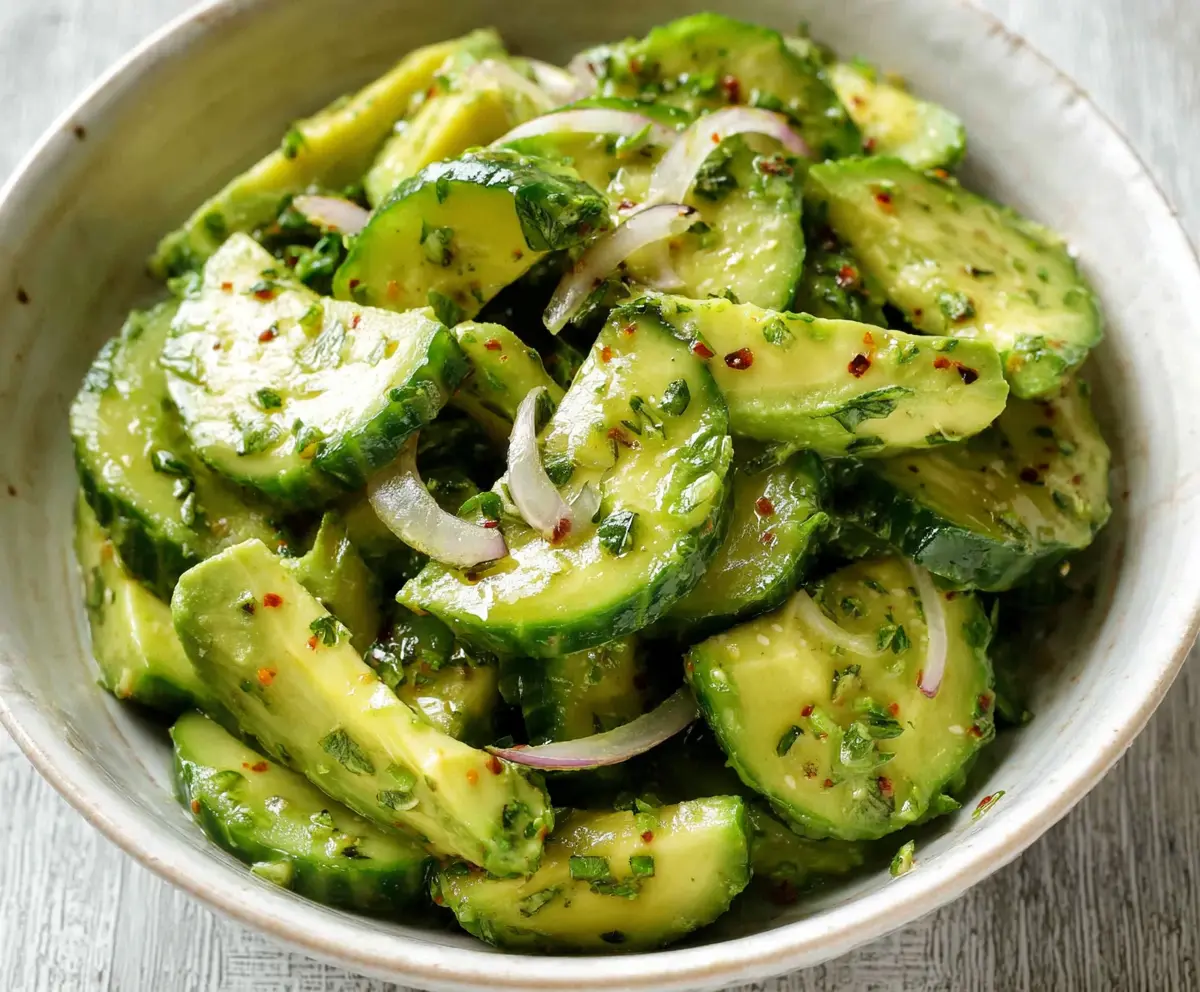 Fresh cucumber and avocado salad served in a bowl, highlighting healthy eating and nutritious ingredients.
