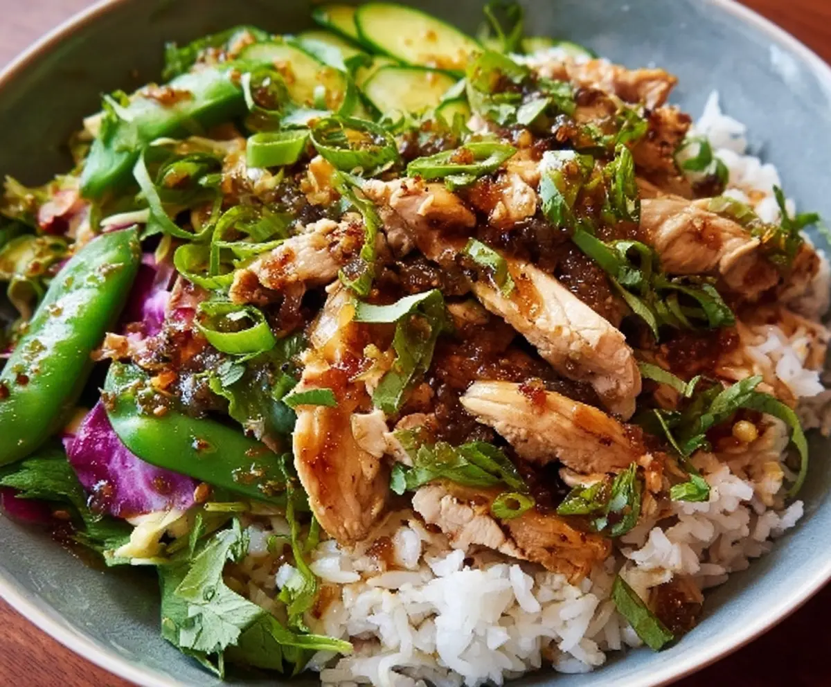 Delicious Ginger Scallion Chicken Bowl with fresh greens and vibrant herbs