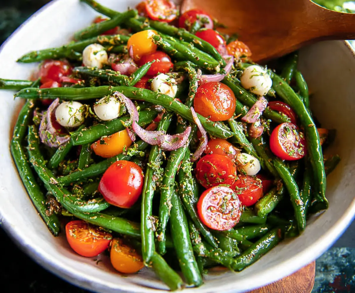 Fresh green bean salad with cherry tomatoes, red onions, and a lemon vinaigrette.