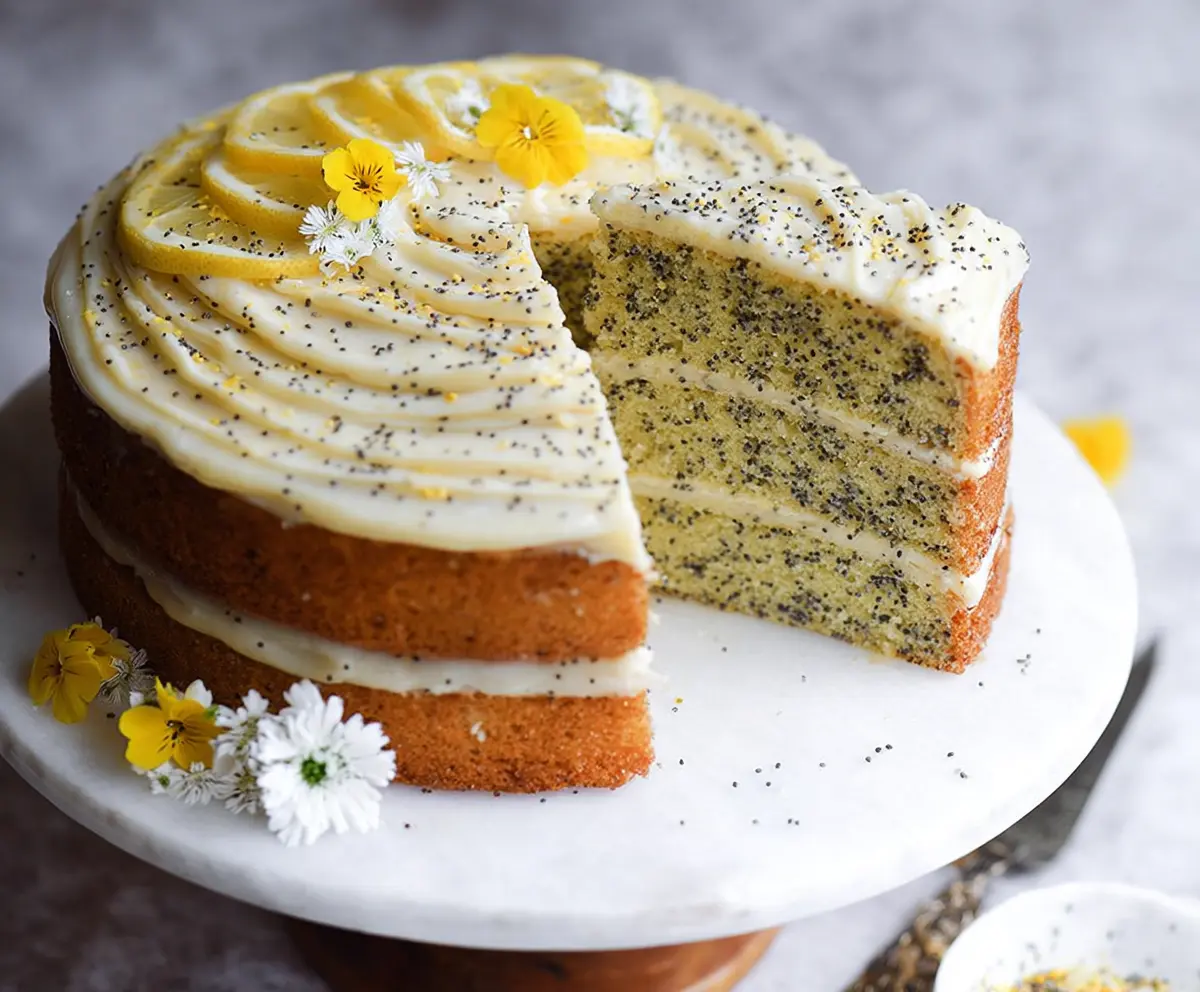 Delicious Lemon Poppy Seed Cake with a zesty lemon glaze and poppy seeds on top.